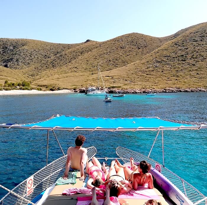 A family relaxing on the sun deck of a charter boat.